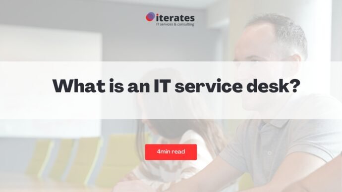 Image avec un arrière-plan de bureau flou affichant une bannière sur laquelle est écrit « Qu'est-ce qu'un centre de services informatiques ? » en texte gras. En dessous, il y a un bouton rouge intitulé « 4 minutes de lecture ». Le logo « iterates IT Services & Consulting » se trouve en haut.